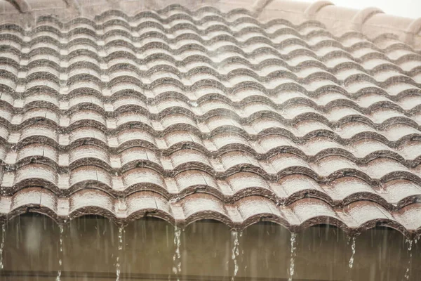 rain falling down from the house roof