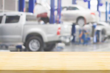 Boş ahşap masa üstü ve araba servisi merkezi oto tamir atölyesi bulanık arkaplan