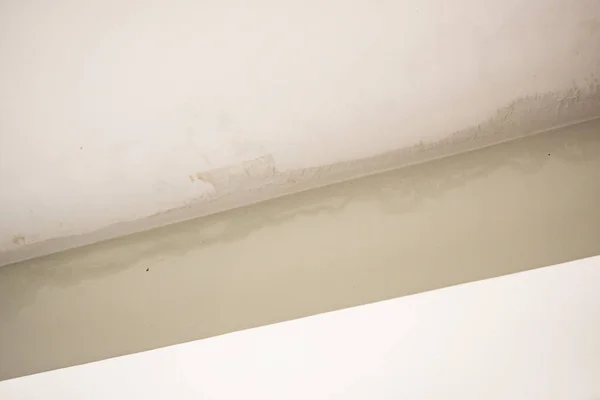 Rain water leak damaged ceiling close up