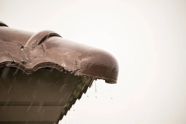 rain falling down from the house roof