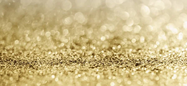 Soyut altın parıltısı arkaplan ile bulanıklaştırılmış