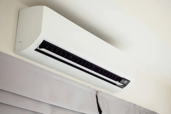 Air conditioner on white wall room interior background