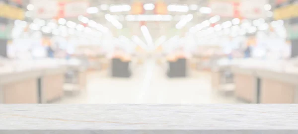 marble table top with supermarket grocery store blurred background with bokeh light for product display