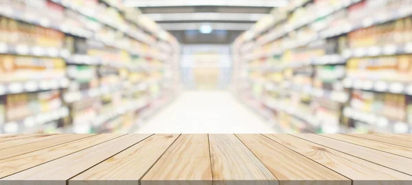 Wood table top with supermarket grocery store aisle interior blurred background with bokeh light for product display