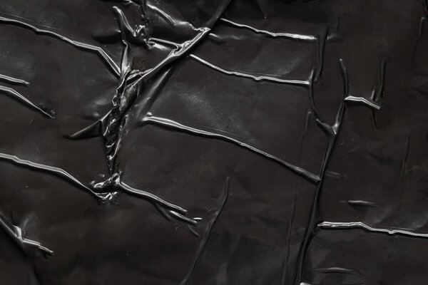 черный скомканный и складчатый пластиковый фон плаката текстуры