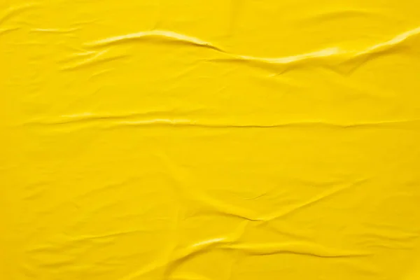 yellow crumpled and creased paper poster texture background