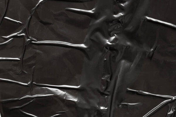 черный скомканный и складчатый пластиковый фон плаката текстуры