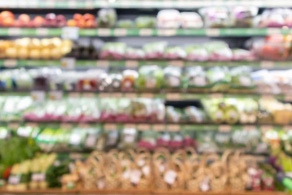 Grocery store shelves with fruits and vegetables blurred background