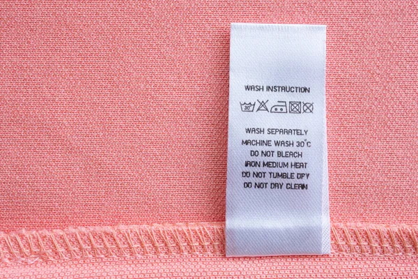 White Laundry Care Washing Instructions Clothes Label Pink Cotton Shirt — Stock Fotó