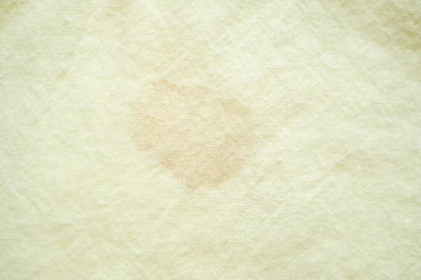 dirty color stain on yellow fabric texture background