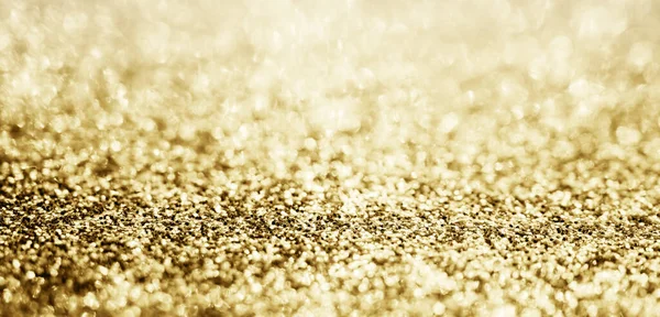 Abstract gold glitter sparkle blurred with bokeh background