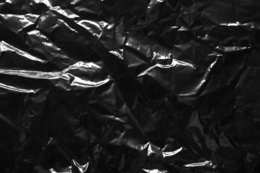 transparent plastic bag film wrap overlay texture on black background