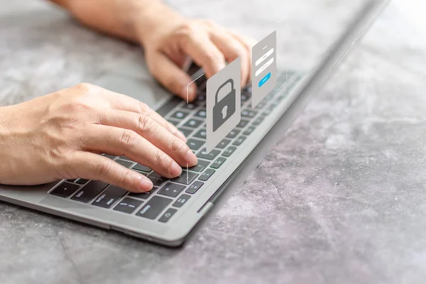 Man typing on keyboard to use computer network. Laptop screen showing login for security system. Concept work at home with computers and Internet. Notebook computer on table. close up, blur background