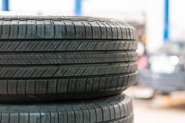 Tires for wheels are sold in car service centers. Closeup, copy space, Blurred background.