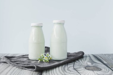 beverage liquid milk white fresh natural two glass bottles on table drink to healthy has protein and calcium for child or toddler, nobody, closeup, white background and copy space on left for content