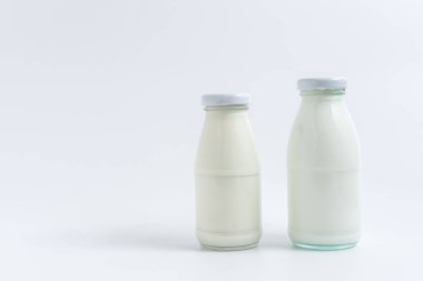 beverage liquid milk white fresh natural two glass bottles on table drink to healthy has protein and calcium for child or toddler, nobody, closeup, white background and copy space on left for content