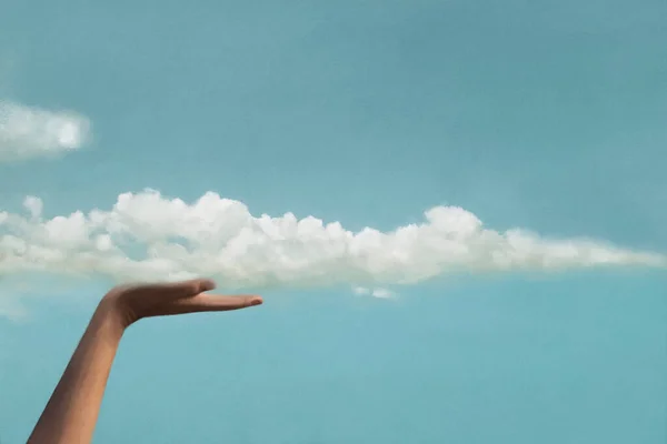 surreal moment between a cloud and a hand of a person