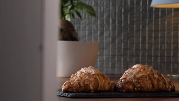 Deux délicieux croissants frais sur un plateau sur la table — Video