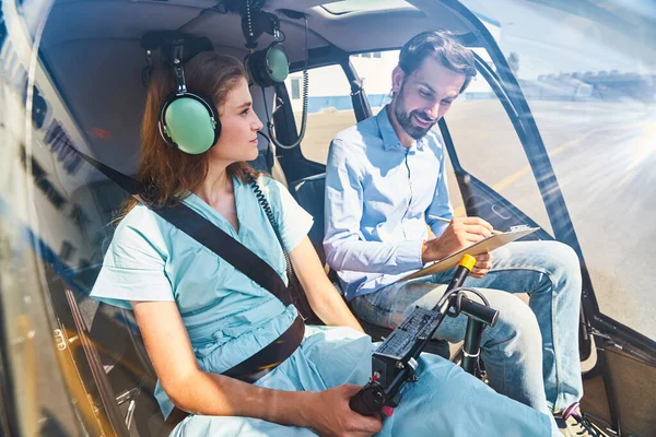Young woman taking flying lesson from experienced airman — Stock Photo, Image