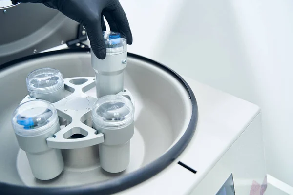Researcher putting test tube into laboratory centrifuge — Stock Photo, Image