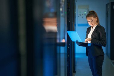 İnternet sunucu odasında çalışan çekici kadın.