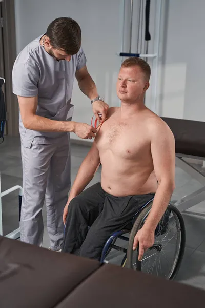 Kinesiotherapie der Schulter des Rollstuhlfahrers mit Kinesiotape — Stockfoto