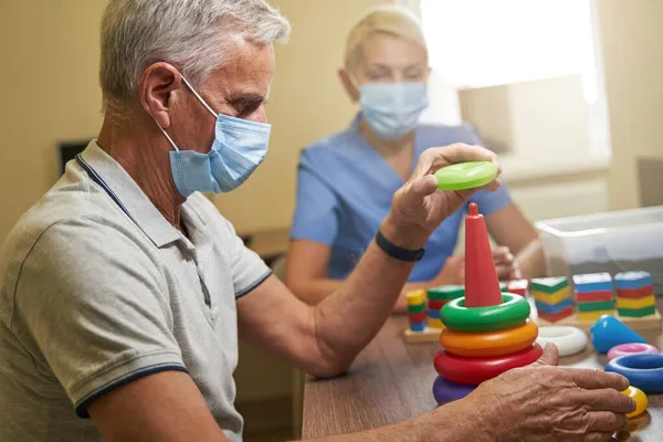 Shot of mature person while recovery of motor skills indoors — Stock Photo, Image
