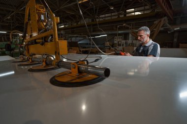 Ciddi yaşlı usta yeni cilalama ekipmanlarını test ediyor