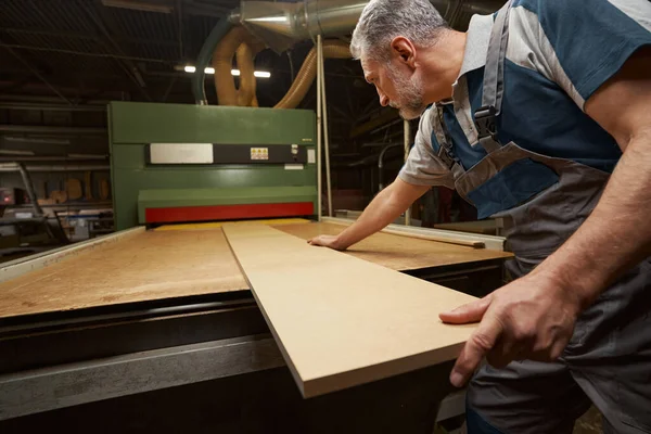 Attentive male person working at woodworking manufacture — Foto Stock