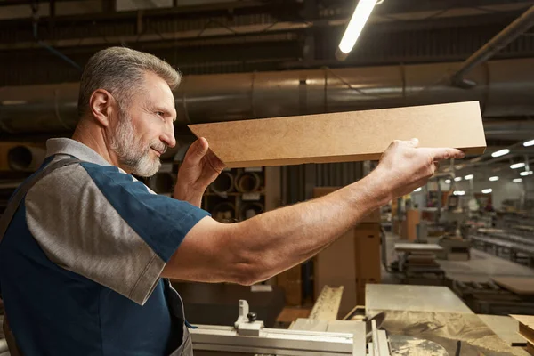 Positive delighted male joiner being in workshop — Foto Stock