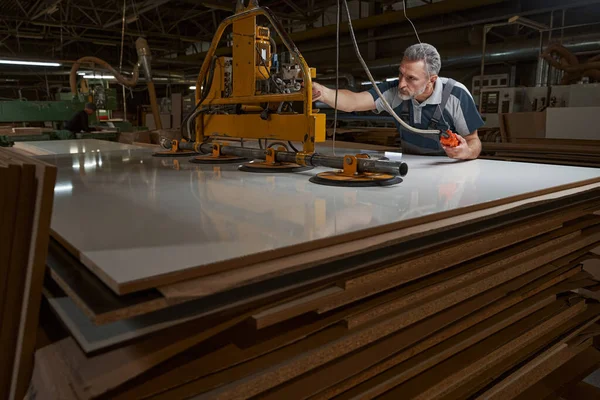 Professional joiner working with modern polishing machine — Stockfoto