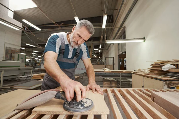 Serious craftsman working at modern furniture manufacture — Zdjęcie stockowe
