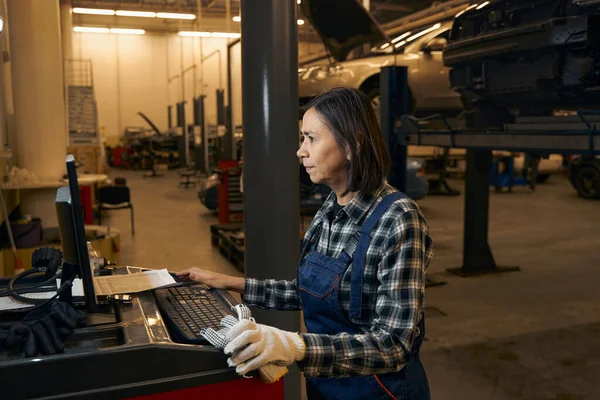 Concentrated female machanic working hard at a warehouse — Stockfoto