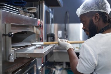 Şef çok çalışıyor, restoranda yemek pişiriyor.