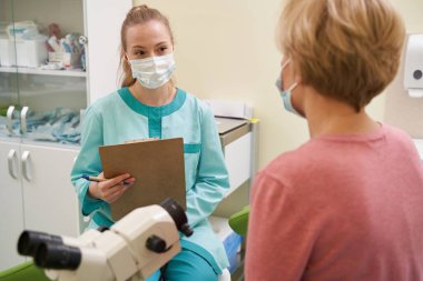 Tıp merkezinde çalışan uzun saçlı hoş bir kadın.