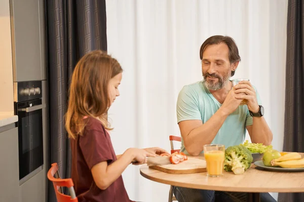 大男人和他的女儿坐在厨房桌旁 — 图库照片