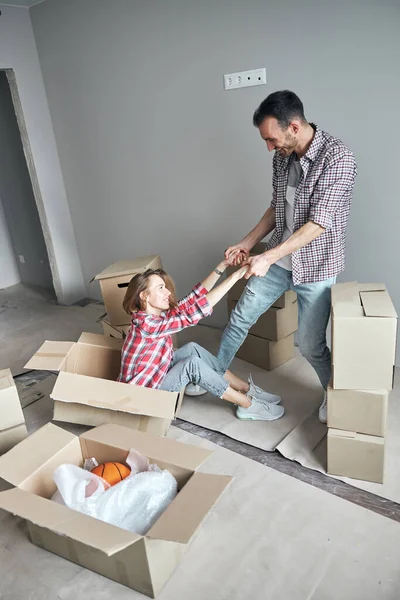 Smiling lady being raised to her feet — Stock Photo, Image