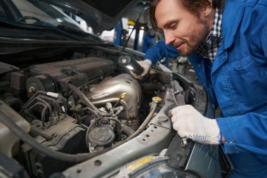 Servis merkezinde çalışan aracı olan adam