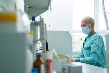 Woman medical worker working with computer in clinic