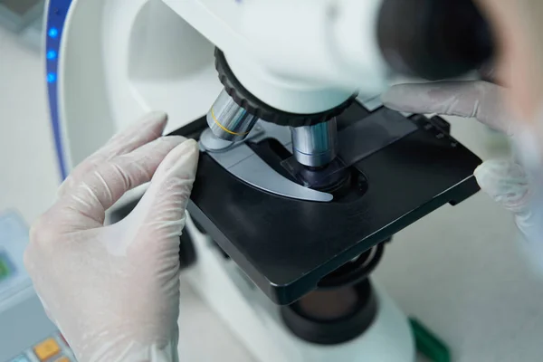 Female laborant researching samples on medical glass — Stock Photo, Image