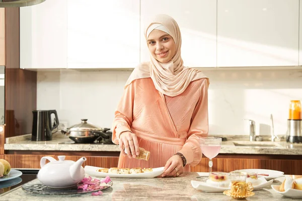 Cheerful Muslim woman cooking food for lunch at home — 스톡 사진