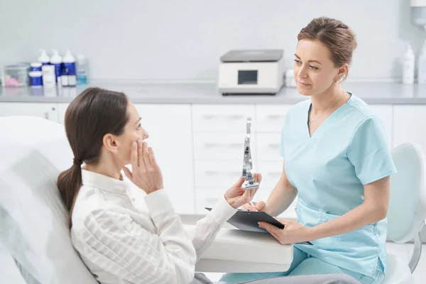 Woman having consultation with doctor in cosmetology clinic — Stock Photo, Image