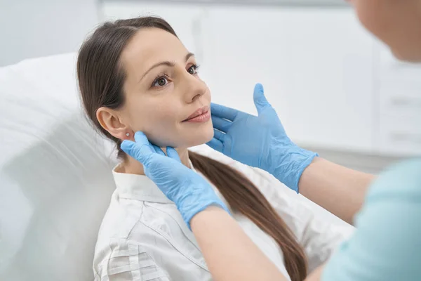 Female patient having facial skin examination in beauty salon — Stock Photo, Image
