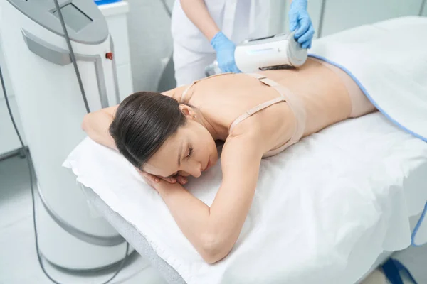 Female Lying Bra Couch While Beautician Tightening Her Back Skin — Zdjęcie stockowe