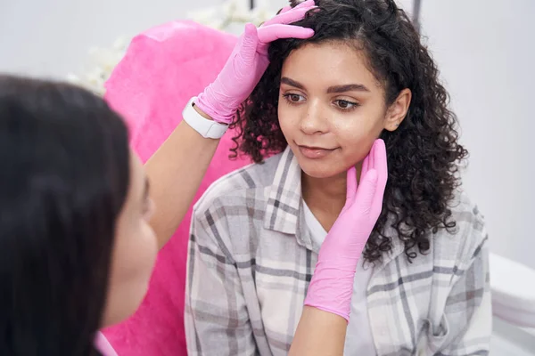 Cosmetologist is conducting a professional examination of the patient face — Stock Photo, Image