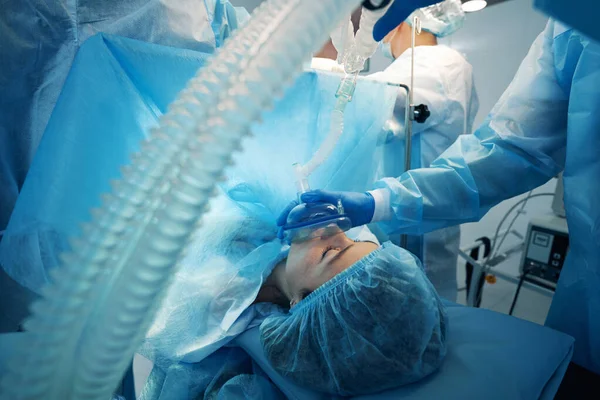 Dokter menutupi mulut dan hidung pasien dengan masker pasokan oksigen — Stok Foto