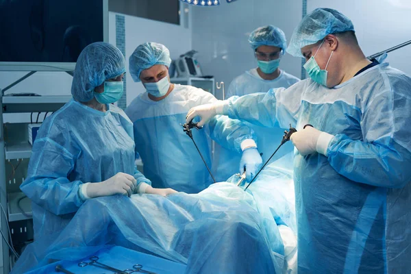 Careful Gynecologist Using Hysteroscope While Treating Patient His Colleagues Helping — Stock Photo, Image