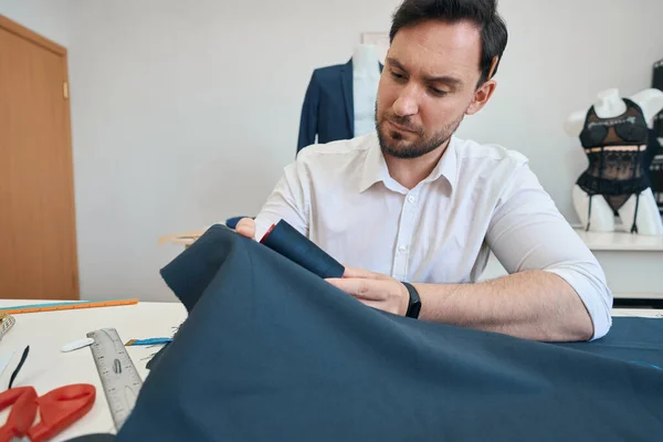 Serious Fashion Designer Sitting His Desk While Picking Threads Sewing — Foto de Stock