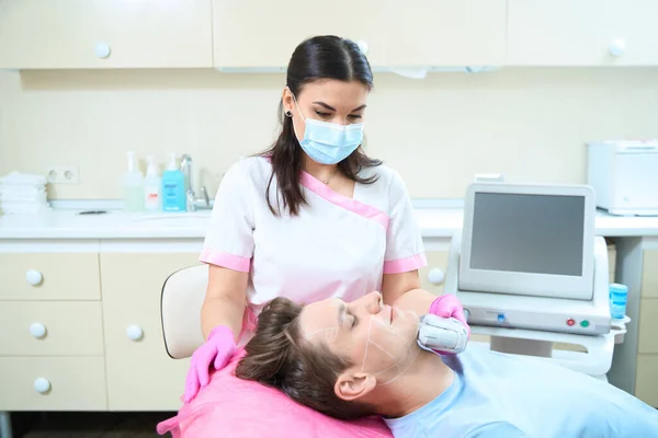 Young Man Visiting Beauty Clinic Antiage Procedures Being Treated Woman — Foto Stock