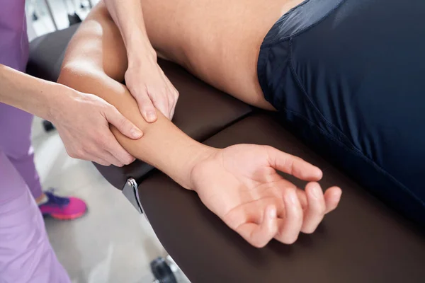 Close Female Professional Masseuse Massaging Male Arm While Man Lying — 图库照片